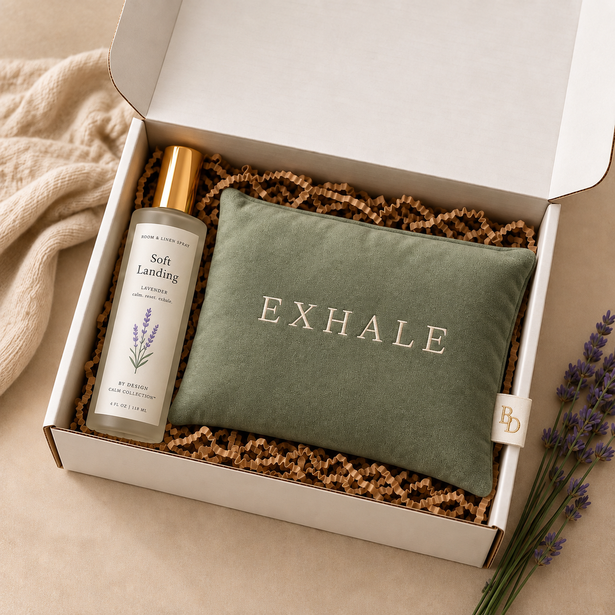 Soft Landing Lavender Room & Linen Spray and EXHALE Weighted Eye Pillow arranged together in an open gift box.