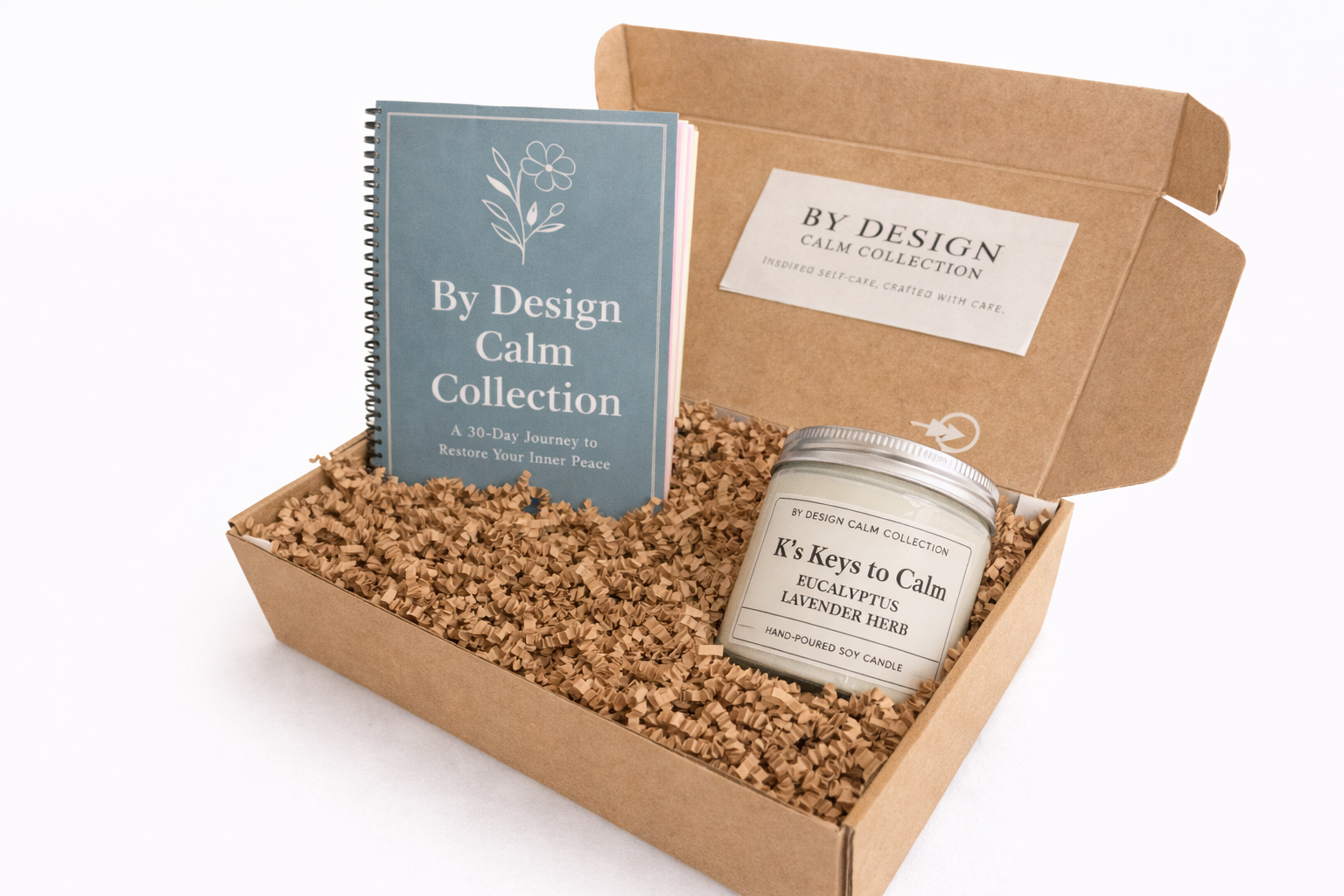 By Design Calm Collection with a book and a candle in a cardboard box on a white background