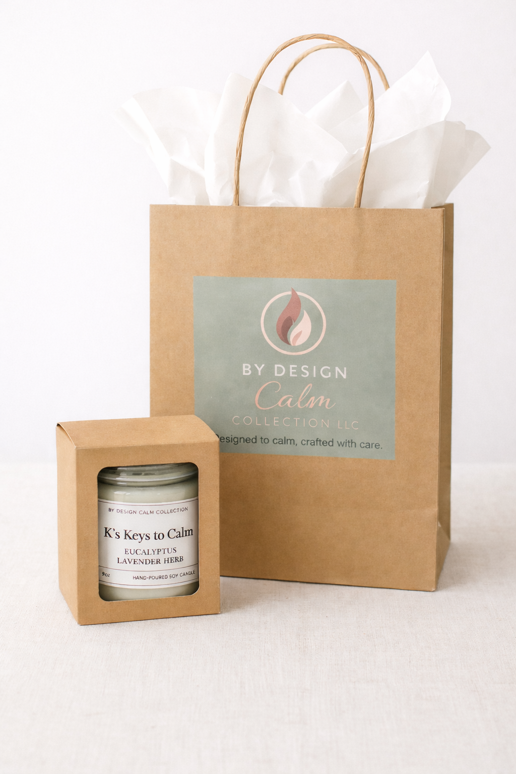 Candle in a box with a branded gift bag on a white background