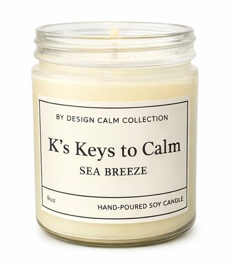 Candle in a glass jar labeled 'K's Keys to Calm Sea Breeze' from the By Design Calm Collection.