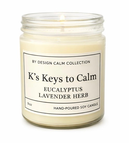 Candle jar labeled 'K's Keys to Calm' with eucalyptus lavender herb scent on a white background