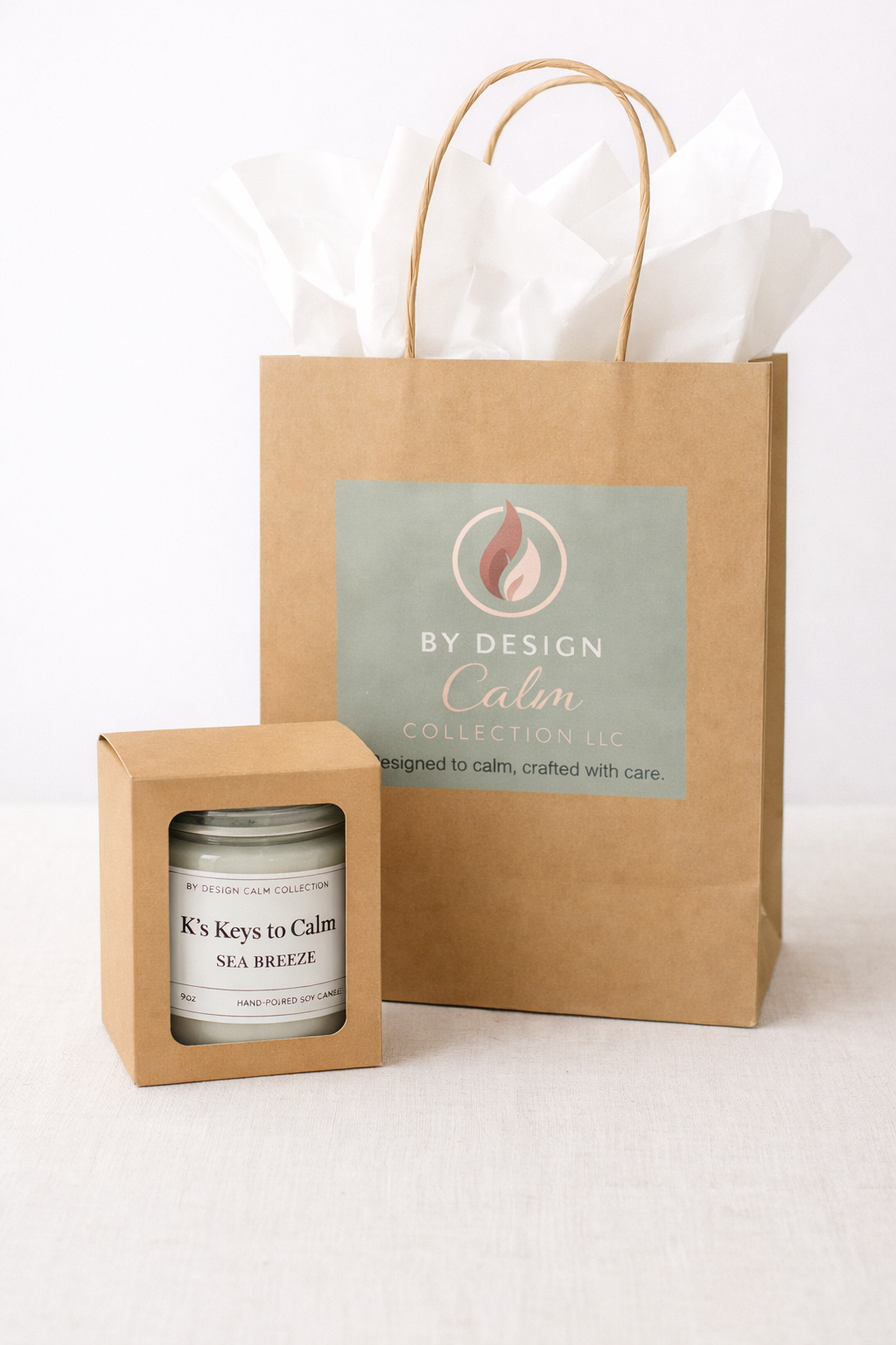 Candle in a box with a branded gift bag on a white background