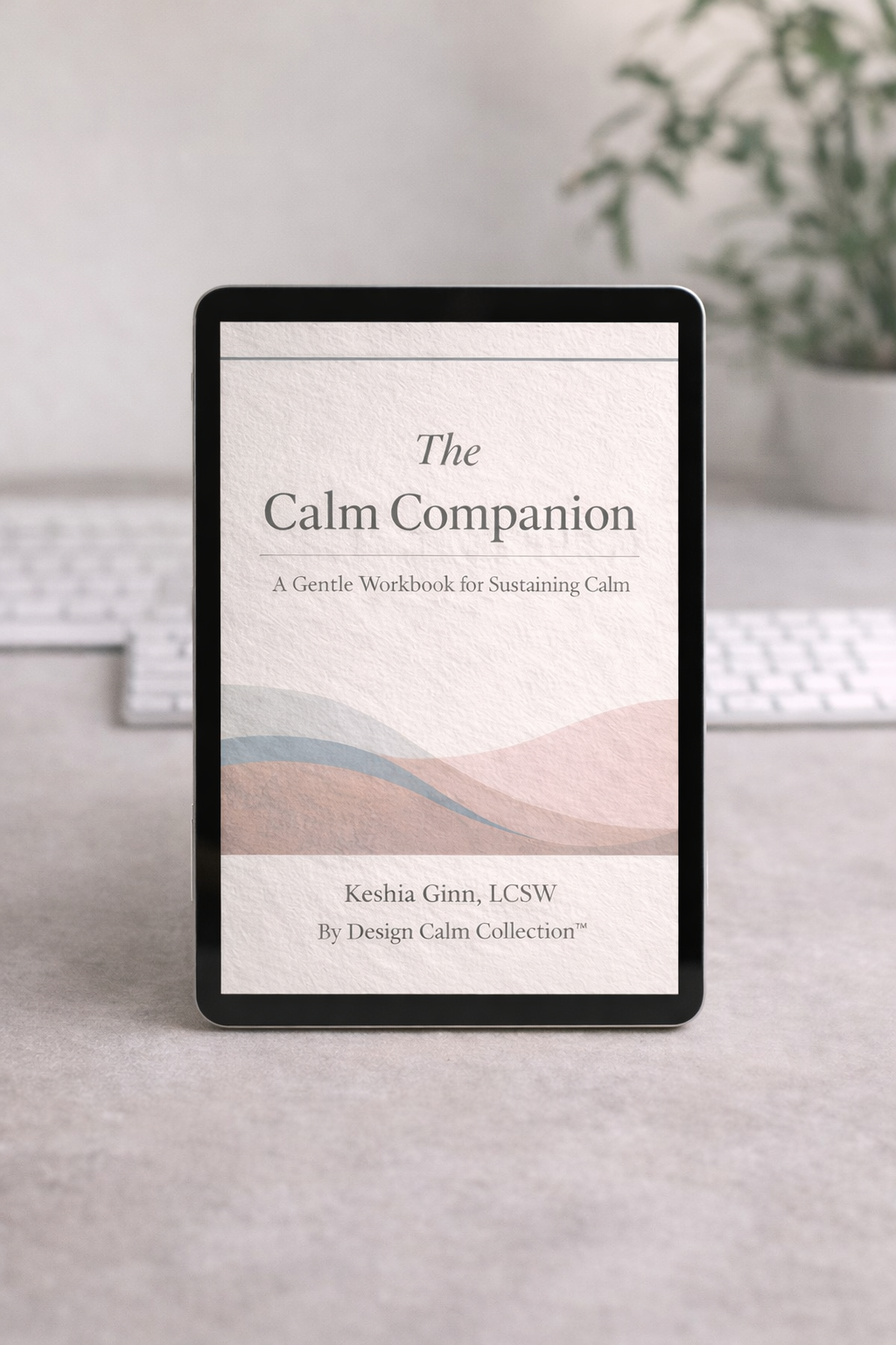 E-reader displaying 'The Calm Companion' on a desk with a plant and keyboard in the background