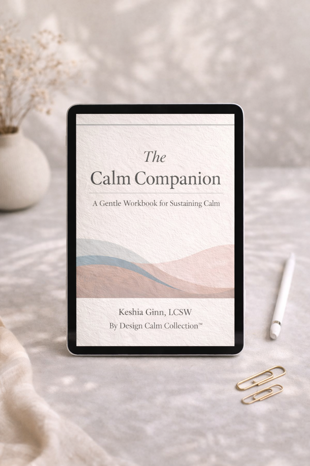 Digital tablet displaying 'The Calm Companion' on a soft surface with decorative items.